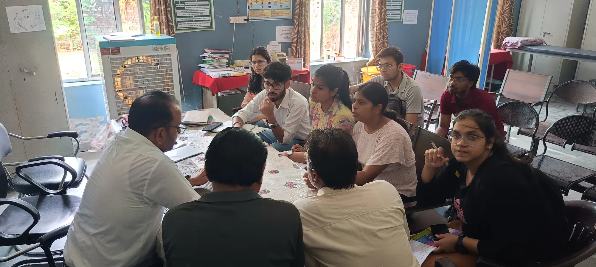 Another view of the discussion, with participants listening across the table.